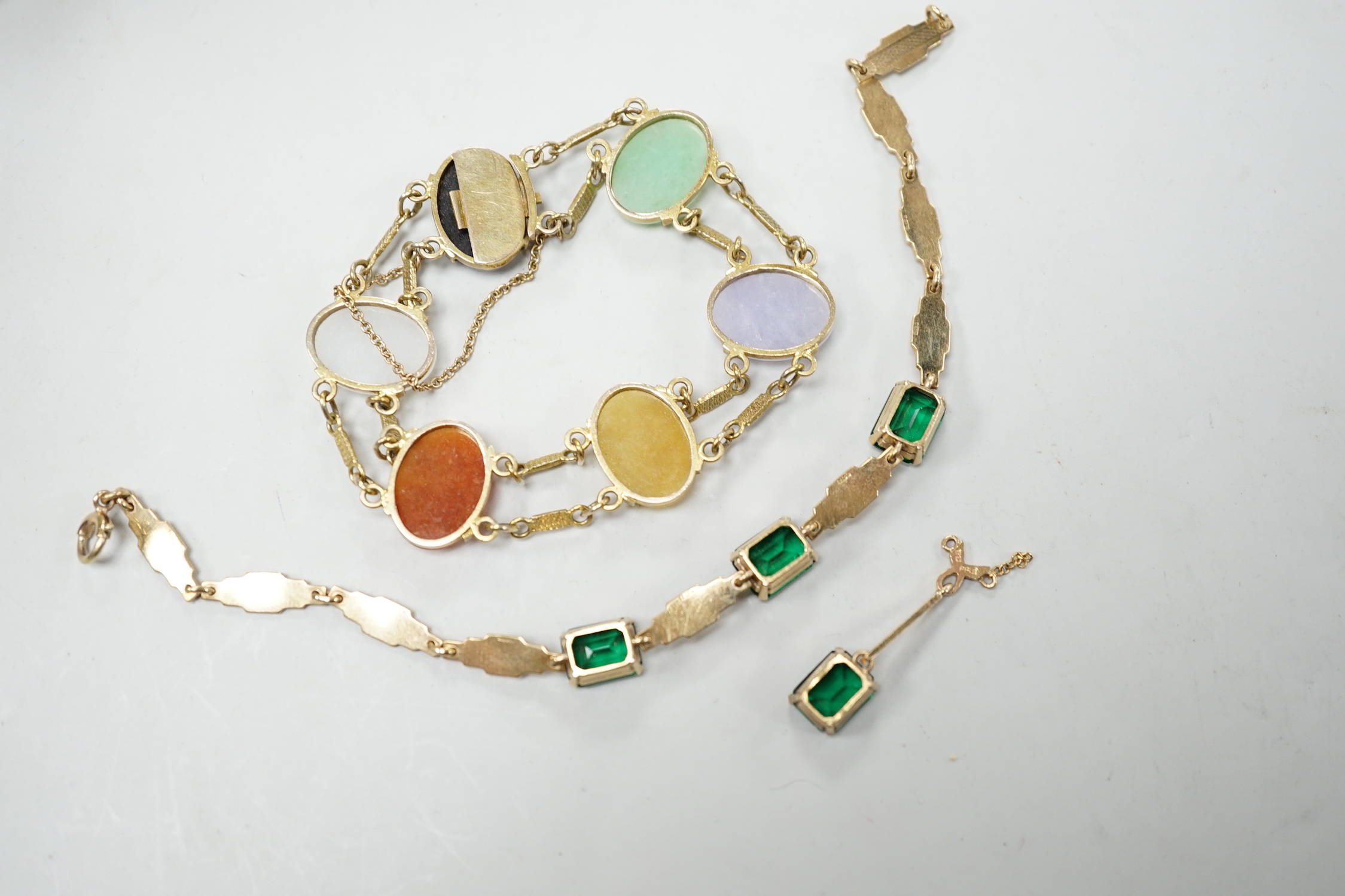 A yellow metal and semi precious cabochon stone set bracelet, 16cm, together with a 9ct gold and green stone set bracelet and one earring.